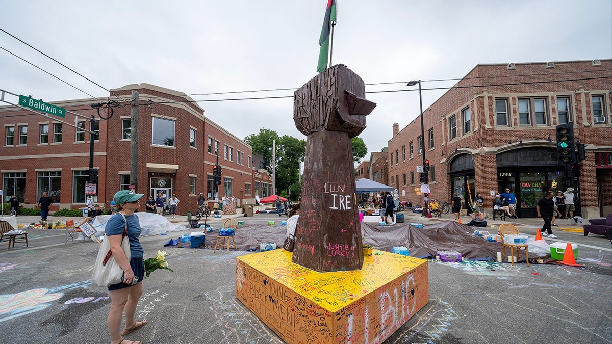 A raised-fist sculpture stands at the Corey Ruiz protest encampment in Madison, Wisconsin.