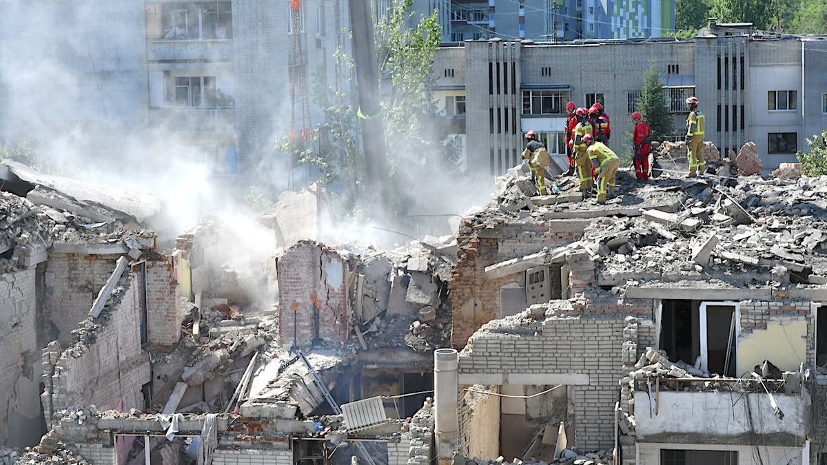 Emergency workers clear rubble with heavy equipment in Lviv, Ukraine.