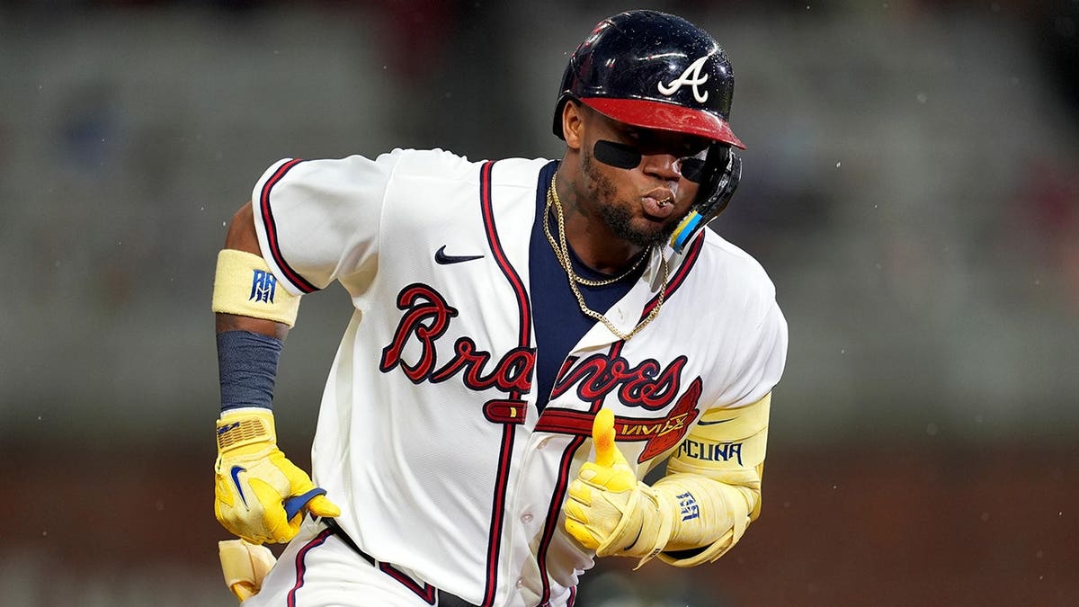 Ronald Acuña Jr. runs after hitting a two-run homer in a baseball game.