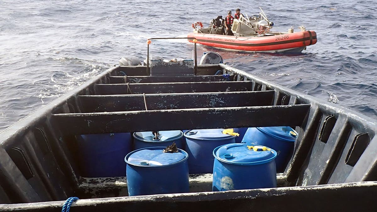 image shows boat with blue containers.