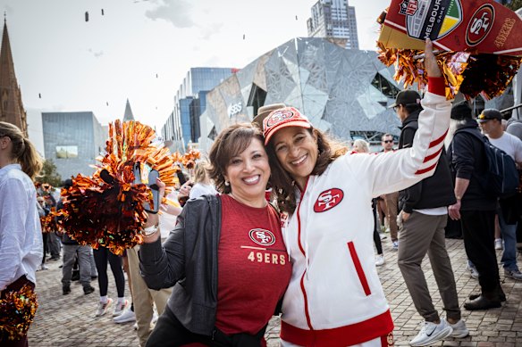 Stefanie Shackelford (left) from California and Tricia Escamilla from Texas met on Sunday in Federation Square and bonded over their shared love of the San Francisco 49ers.