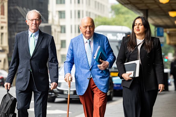Alan Jones and his lawyers arrive at the Downing Centre on Thursday. 