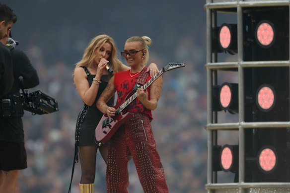 G Flip joins Kylie Minogue on stage at the AFL grand final.