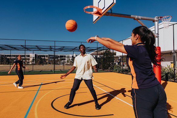 Year 9 and 10 students Keya Patel, Ayo Okeowo and Jesnoor Khehra play basketball at Melonba High School, in Sydney’s north-west. The school has opened its basketball court to the public.