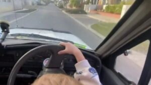 Man arrested over video of three-year-old steering car