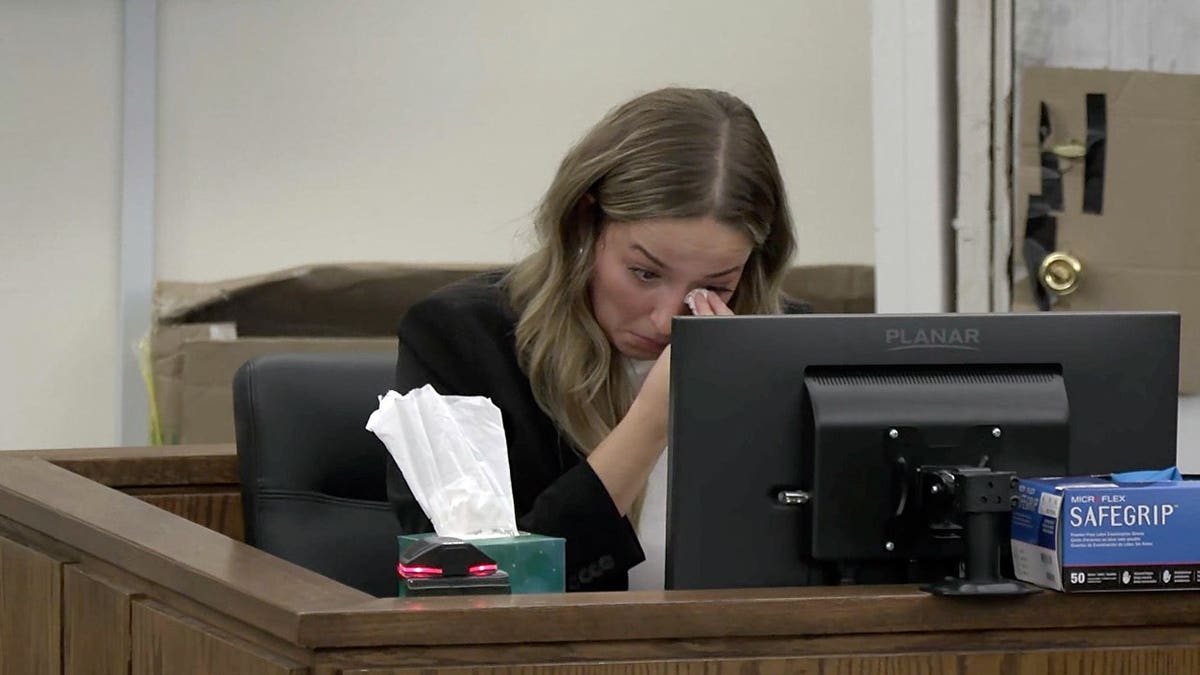 Alleigha Botner wipes tears from her eyes while testifying from the witness stand during Caleb Flynn’s murder trial in Ohio.