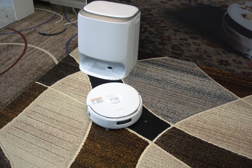 Narwal vacuum set to task on a dirty carpet.