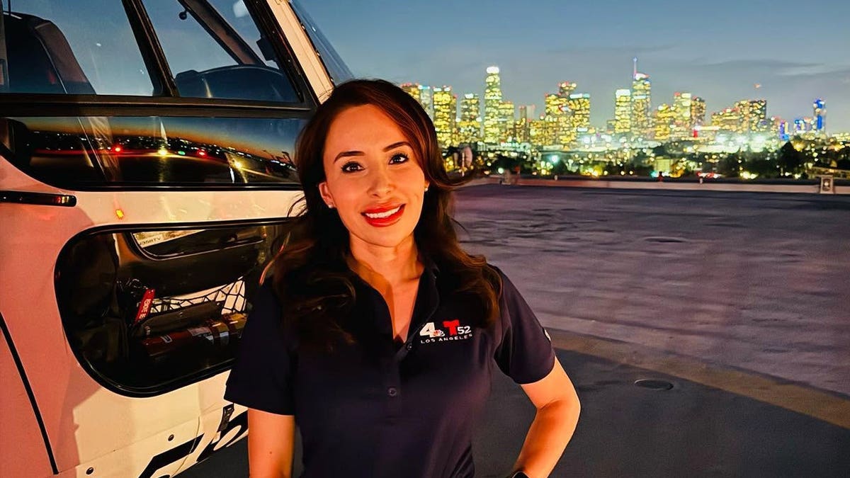 Eliana Moreno poses on a helipad with Los Angeles in the background.