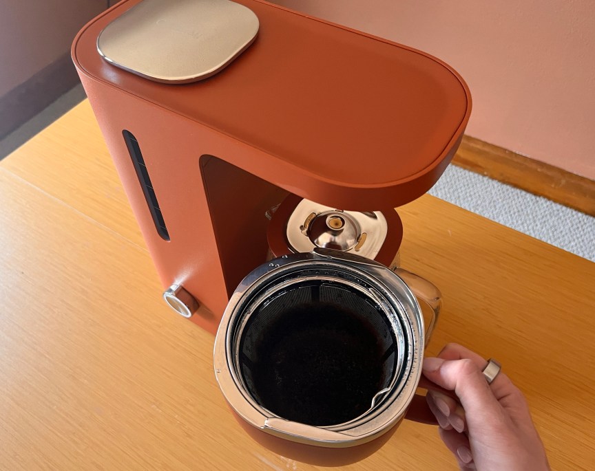 a person holding a coffee brew basket