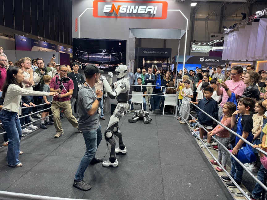 A man and robot pretend to fight