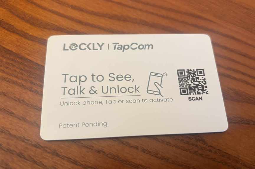 Lockly TapCom card plate on a wood table.