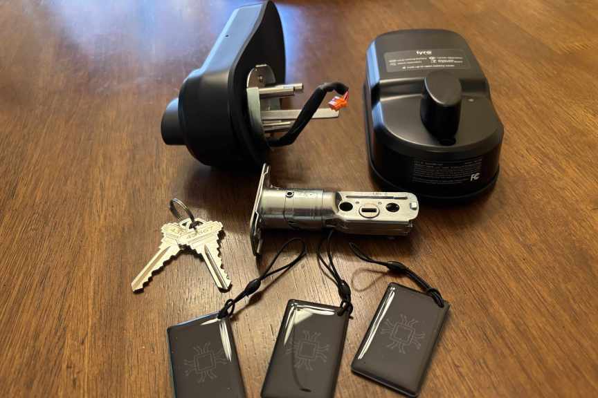 Lyro smart lock in parts on a wood table.