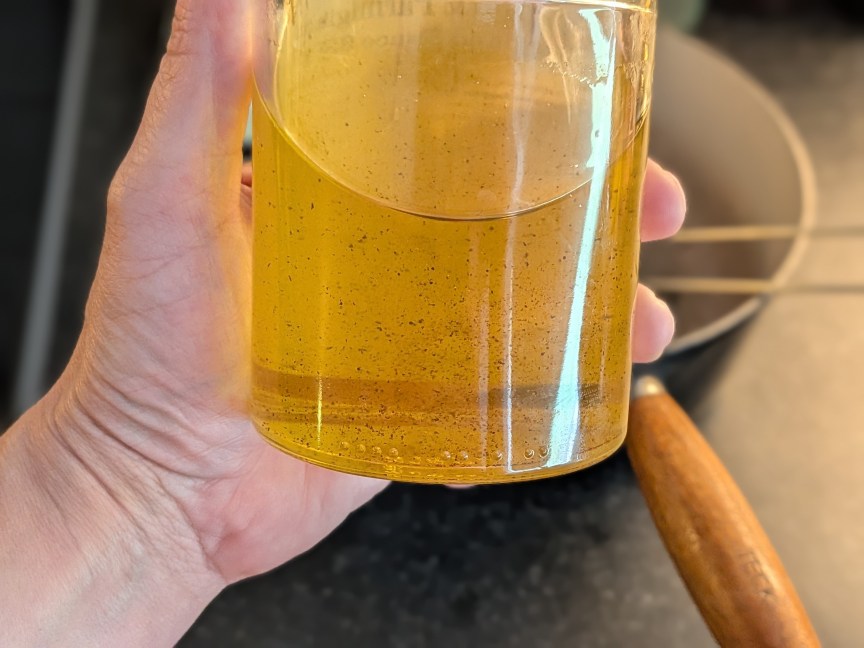 person holding jar of oil