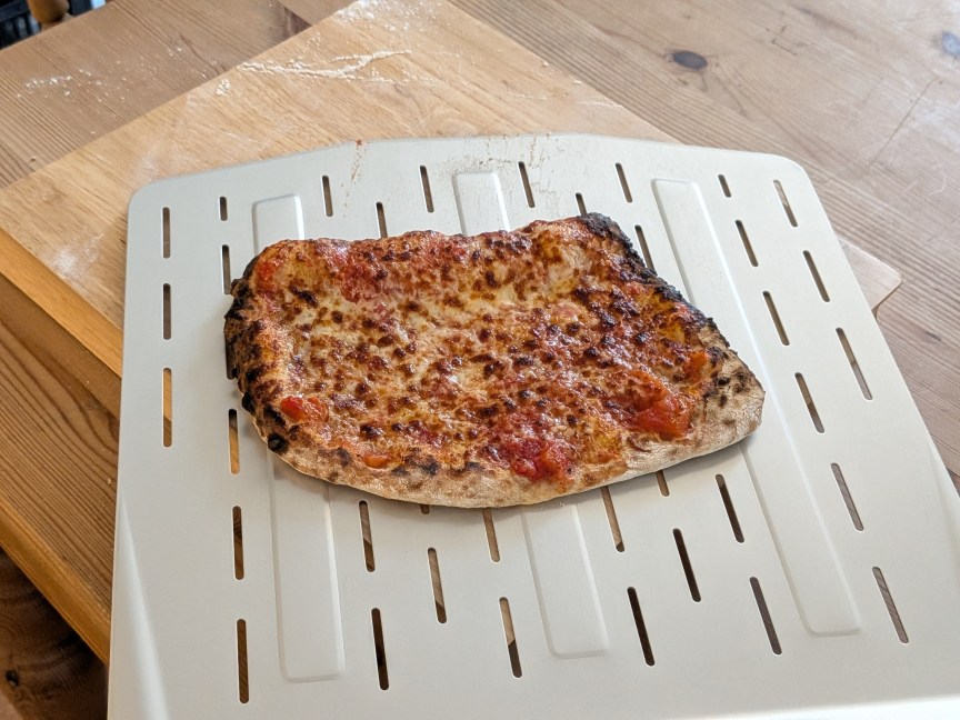 cooked pizza on non-sliding metal pizza peel