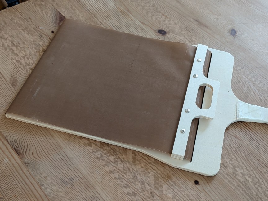 sliding pizza peel on table