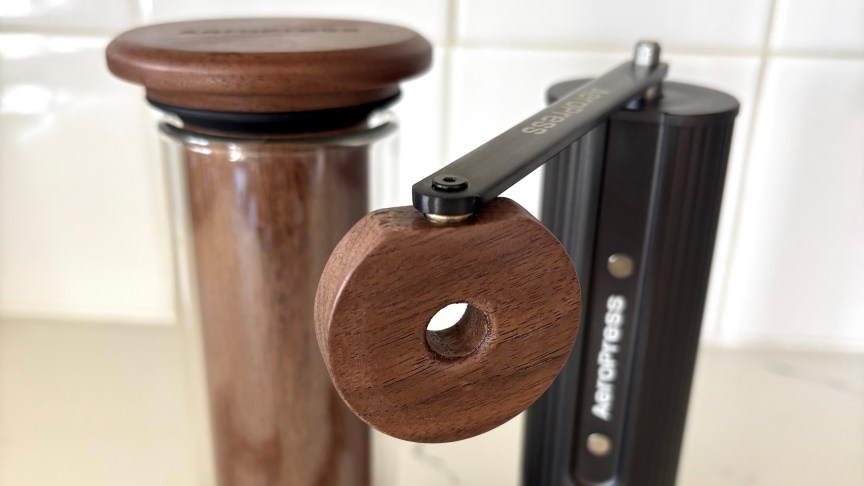 A close-up of the new AeroPress grinder's walnut handle.