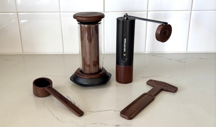 The AeroPress walnut brewer, grinder, scoop and stir.