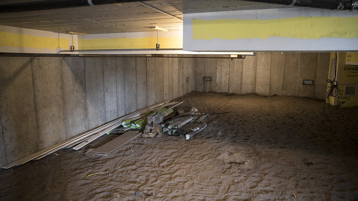 Enclosed crawl space with solid concrete foundation visible in a hurricane-resilient home at Breezy Point, Queens.
