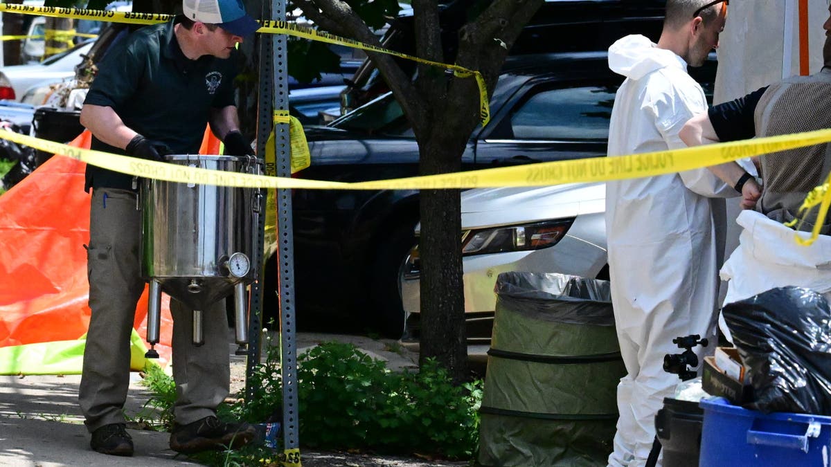 FBI agent removes an autoclave from Eugene Horsch's home in Philadelphia during a raid.