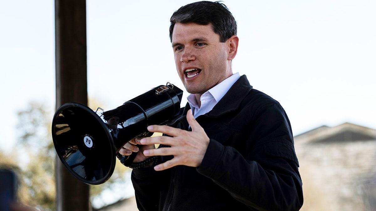 James Talarico speaks into a megaphone