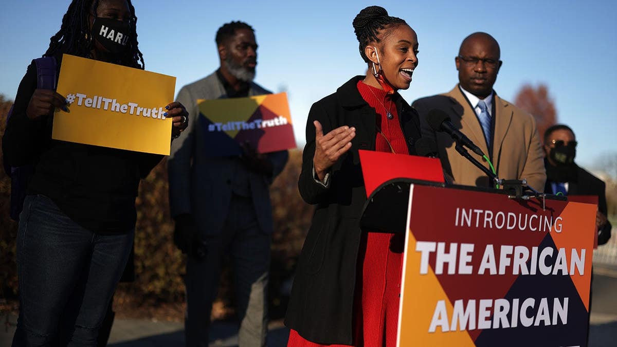 Rep. Shontel Brown speaks as Rep. Jamaal Bowman listens during a news conference.