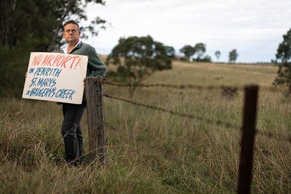 Luddenham resident Wayne Willmington holds an old  “no airport” placard.