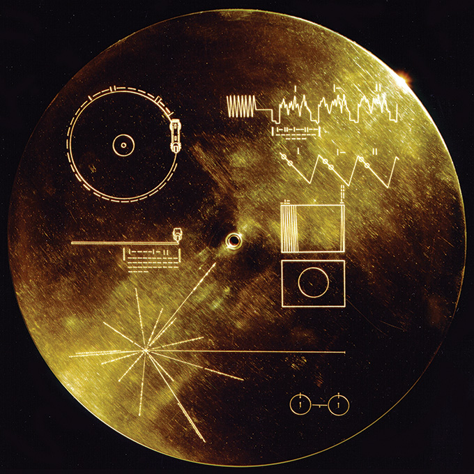 A circular disc, shaped like a vinyl record, with various diagrams etched in white on the surface.