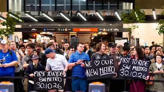 People gather before dawn for the opening of the new Southwest Metro line in Bankstown. The train left the station at 4.31am.