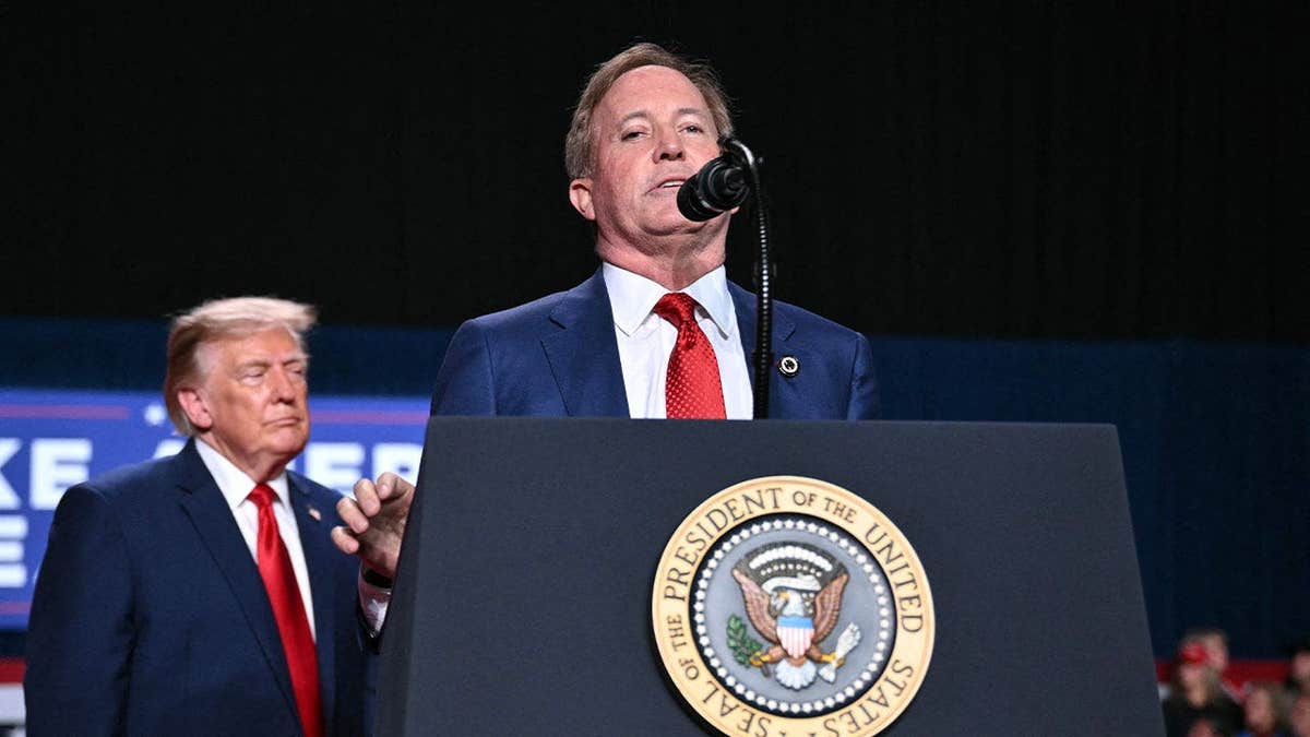 President Donald Trump listens as Ken Paxton addresses a campaign rally in San Antonio, Texas