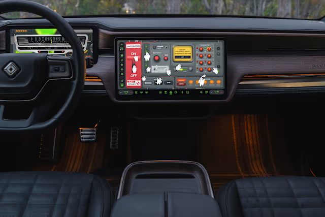 Rivian R1S dashboard with custom Ghostbusters graphics on its two dashboard displays.