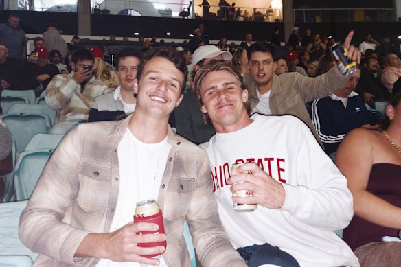 Tommy Cahill (left) and Charlie Farr-Jones in the stands on the final night of greyhound racing at Sydney’s Wentworth Park.