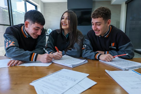 Elevation Secondary College year 12 triplets Savio (left), Saviya and Simon Eeso are among the thousands of students who will sit their English exam this week.
