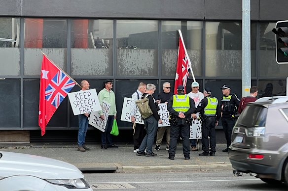 Protesters are spoken to by police on Tuesday morning. 