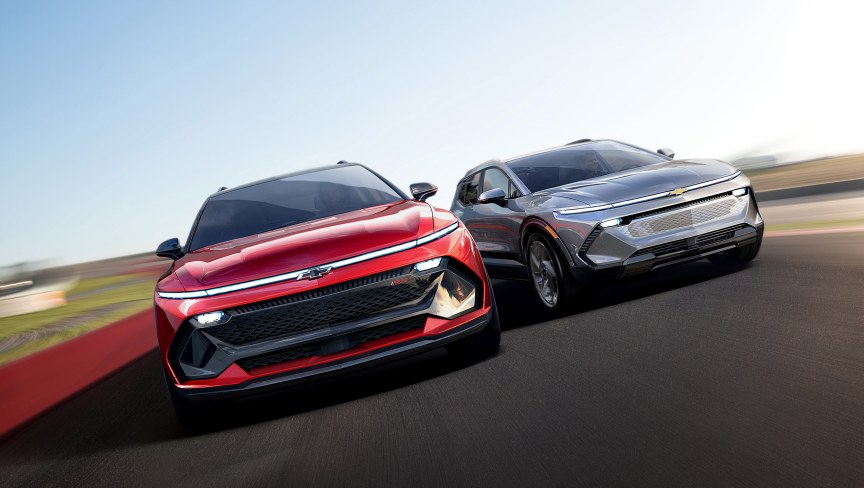 Two Chevrolet Equinox drive towards the viewer, the camera is at a slightly dutch angle.