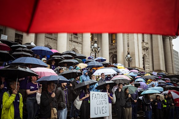 Doctors protesting on the steps of Victoria’s state parliament on Thursday braved torrential rain. 