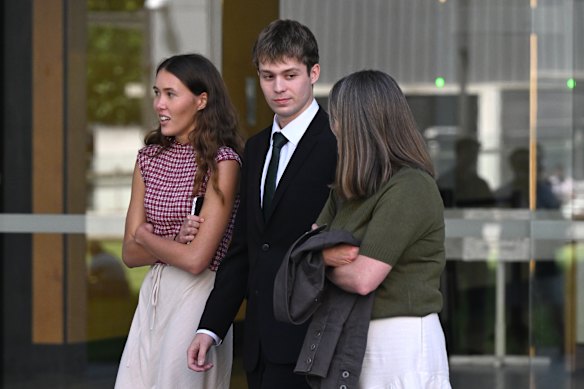 Jake Crawford (centre) attends his father’s trial at the Supreme Court.