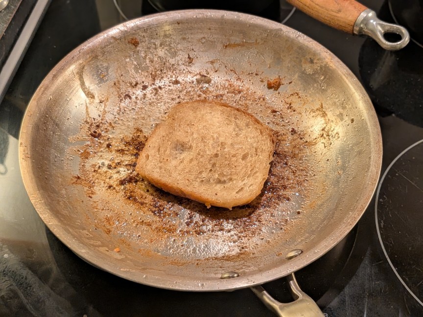 slice of bread in oily pan