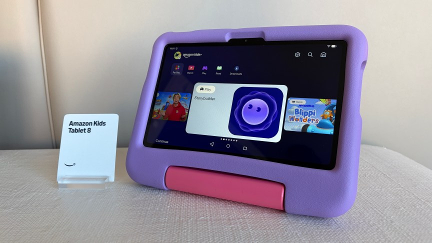 The 8.7-inch Amazon Kids variant of the Alexa Tablet has a foamy purple case. The Storybuilder app icon is visible on the screen.