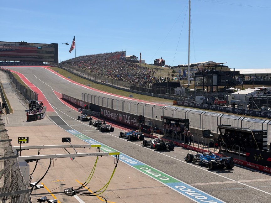 A row of F1 cars lined up