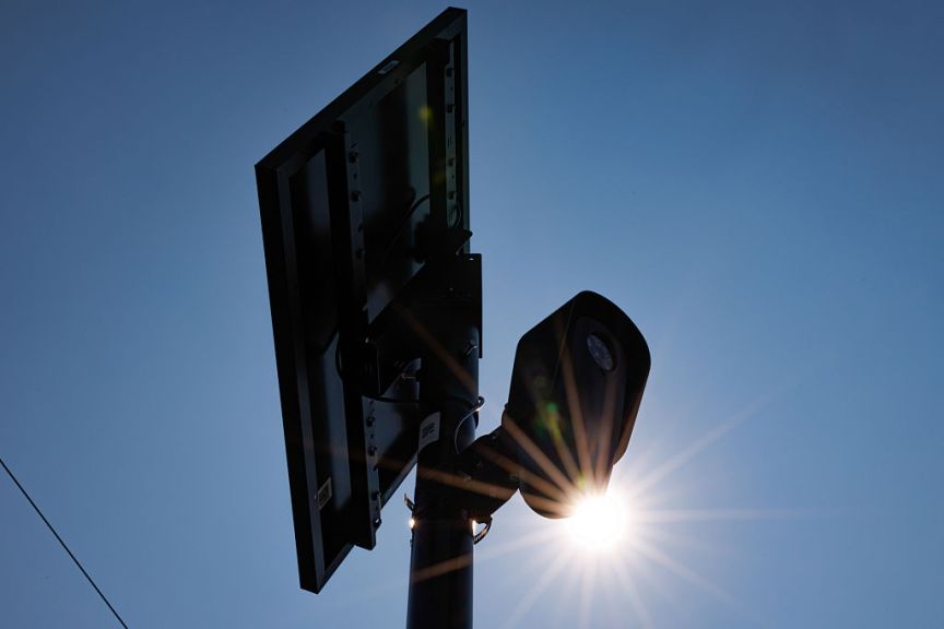 A Flock camera and panel against the sun.