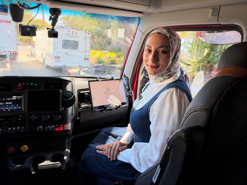 A woman sits in the passenger seat of Kodiak's driverless semi.