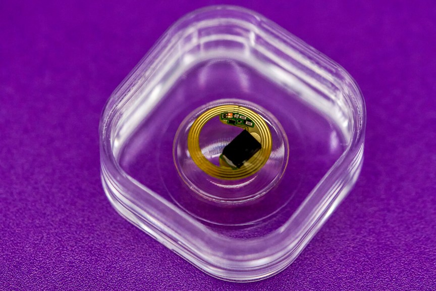 A smart contact lens microbattery in a clear case.