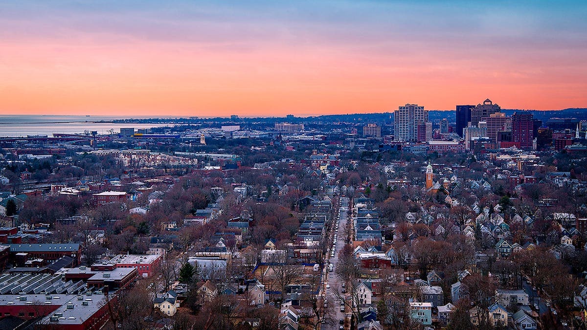 New Haven Connecticut Skyline at Dusk, downtown buildings and houses viewed from East Rock Park Summit at Sunset