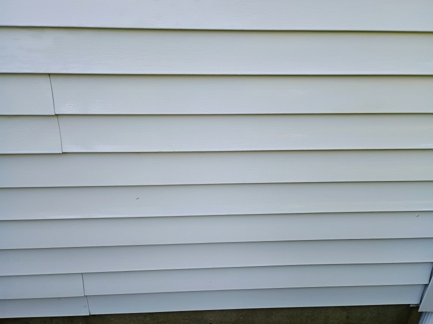 A view of house siding after it was cleaned with the AR Blue Clean pressure washer. The result looks very clean.