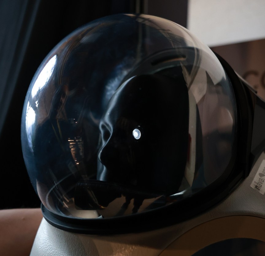 A smart contact lens inside a space suit helmet.