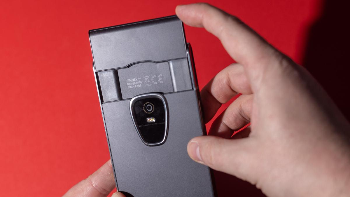 Hands holding the Finney, which has a pop-up screen