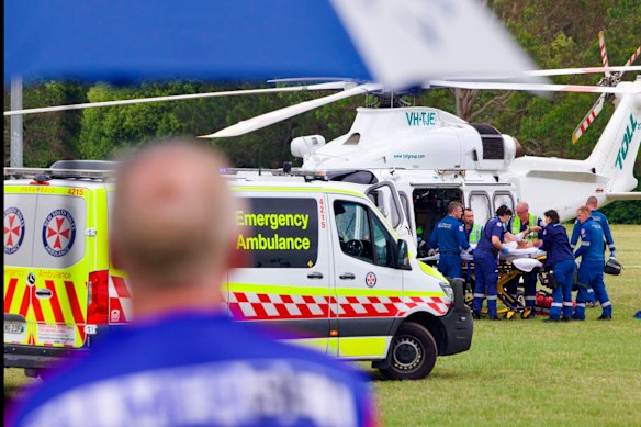 Paramedics prepare to transport the injured by helicopter.