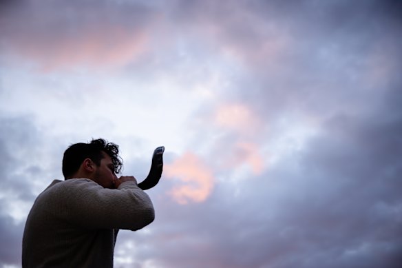 A man sounds the shofar, a ceremonial trumpet, at the Bondi Pavilion during a vigil on the third anniversary of the October 7 attacks on Israel.