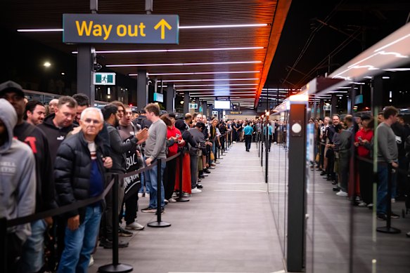 More than 1000 people lined up behind a belt barrier on the platform at Bankstown station before cramming on board the first metro service.