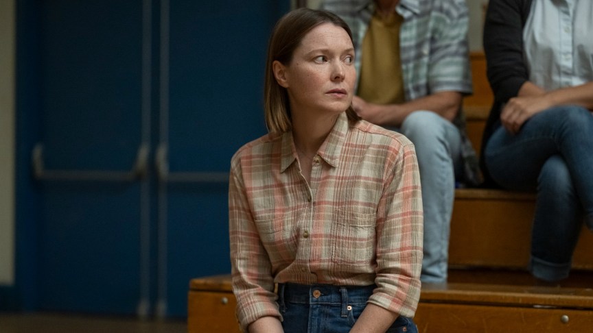 Production still of Samantha Sloyan as Margaret White on a high school bleacher in Carrie.